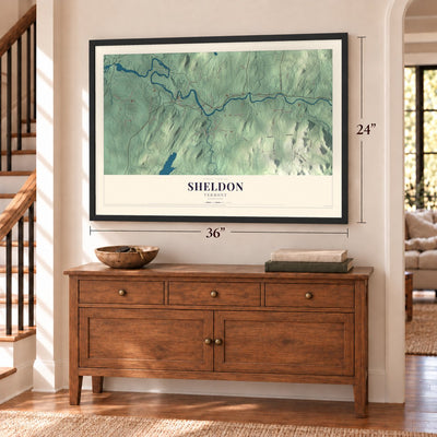Sheldon, Vermont map, 24 x 36 inch print in a black frame above a dresser by a staircase