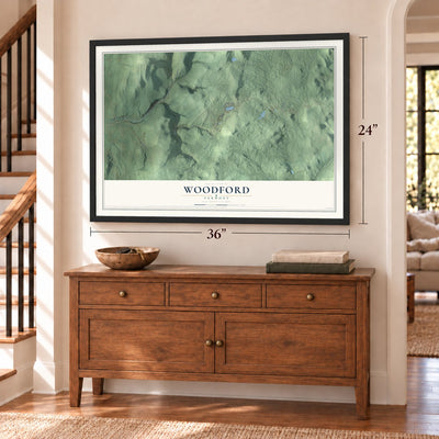 Woodford, Vermont map, 24 x 36 inch print in a black frame above a dresser by a staircase