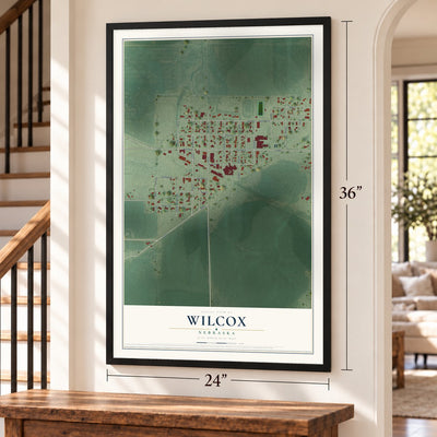 Wilcox, Nebraska map, 24 x 36 inch print in a black frame by a staircase