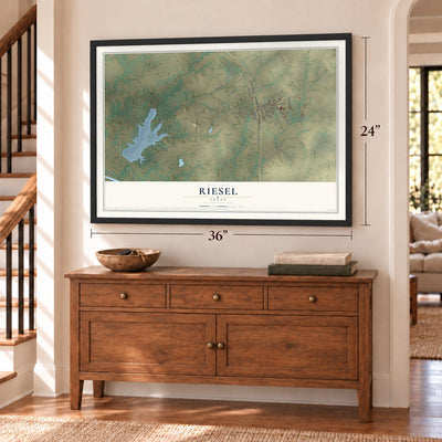 Riesel, Texas map, 24 x 36 inch print in a black frame above a dresser by a staircase