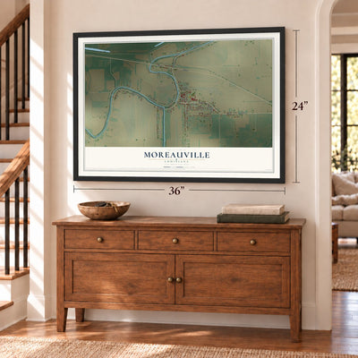 Moreauville, Louisiana map, 24 x 36 inch print in a black frame above a dresser by a staircase
