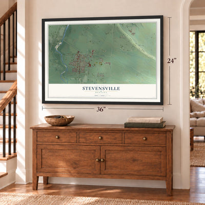 Stevensville, Montana map, 24 x 36 inch print in a black frame above a dresser by a staircase