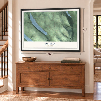 Otisco, New York map, 24 x 36 inch print in a black frame above a dresser by a staircase
