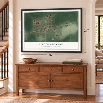 Bronson, Michigan map, 24 x 36 inch print in a black frame above a dresser by a staircase