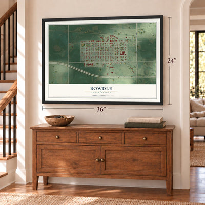 Bowdle, South Dakota map, 24 x 36 inch print in a black frame above a dresser by a staircase