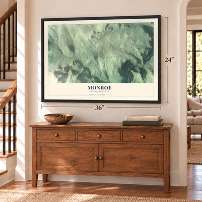 Monroe, Massachusetts map, 24 x 36 inch print in a black frame above a dresser by a staircase