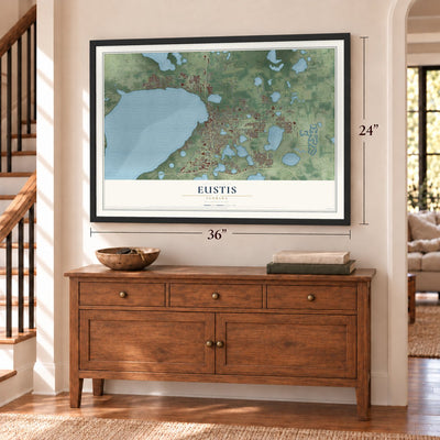 Eustis, Florida map, 24 x 36 inch print in a black frame above a dresser by a staircase