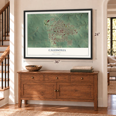 Caledonia, Minnesota map, 24 x 36 inch print in a black frame above a dresser by a staircase