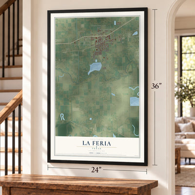 La Feria, Texas map, 24 x 36 inch print in a black frame by a staircase