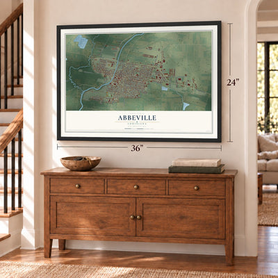 Abbeville, Louisiana map, 24 x 36 inch print in a black frame above a dresser by a staircase