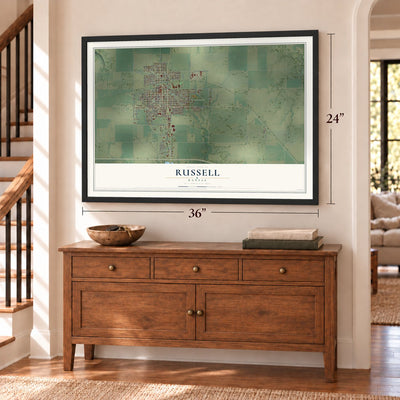Russell, Kansas map, 24 x 36 inch print in a black frame above a dresser by a staircase