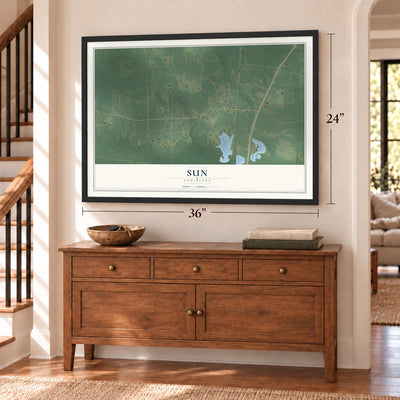 Sun, Louisiana map, 24 x 36 inch print in a black frame above a dresser by a staircase