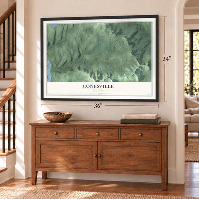 Conesville, New York map, 24 x 36 inch print in a black frame above a dresser by a staircase