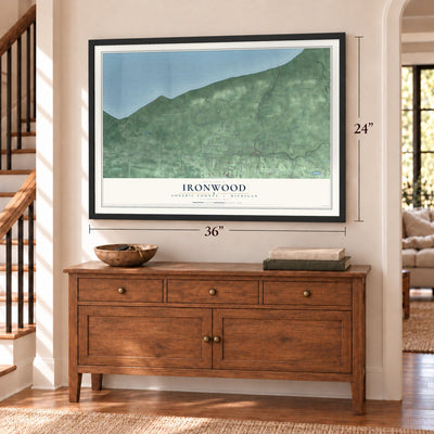 Ironwood, Gogebic County, Michigan map, 24 x 36 inch print in a black frame above a dresser by a staircase