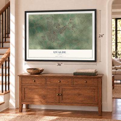 Uvalde, Texas map, 24 x 36 inch print in a black frame above a dresser by a staircase