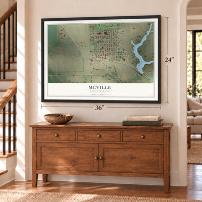 McVille, North Dakota map, 24 x 36 inch print in a black frame above a dresser by a staircase