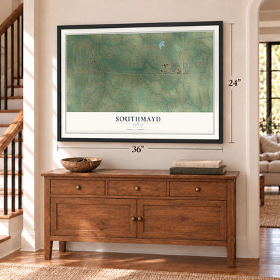 Southmayd, Texas map, 24 x 36 inch print in a black frame above a dresser by a staircase