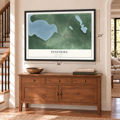 Tenstrike, Minnesota map, 24 x 36 inch print in a black frame above a dresser by a staircase