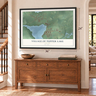 Village of Tupper Lake, New York map, 24 x 36 inch print in a black frame above a dresser by a staircase