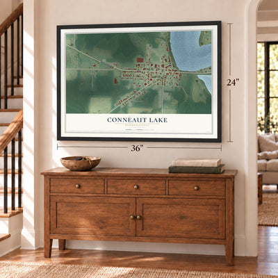 Conneaut Lake, Pennsylvania map, 24 x 36 inch print in a black frame above a dresser by a staircase