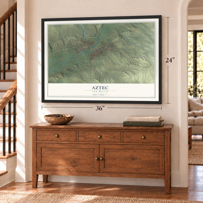 Aztec, New Mexico map, 24 x 36 inch print in a black frame above a dresser by a staircase