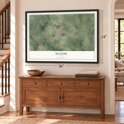 Manor, Texas map, 24 x 36 inch print in a black frame above a dresser by a staircase