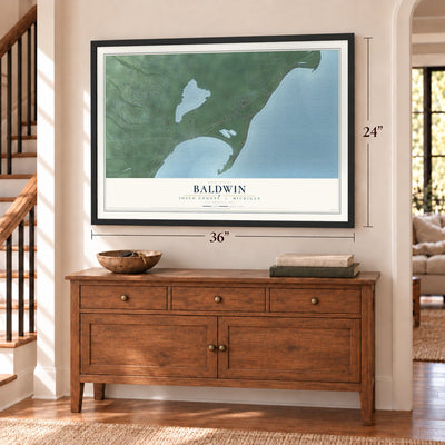 Baldwin, Iosco County, Michigan map, 24 x 36 inch print in a black frame above a dresser by a staircase