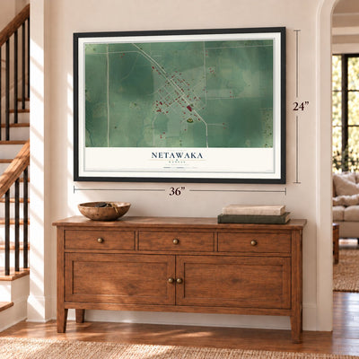 Netawaka, Kansas map, 24 x 36 inch print in a black frame above a dresser by a staircase