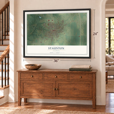 Staunton, Illinois map, 24 x 36 inch print in a black frame above a dresser by a staircase