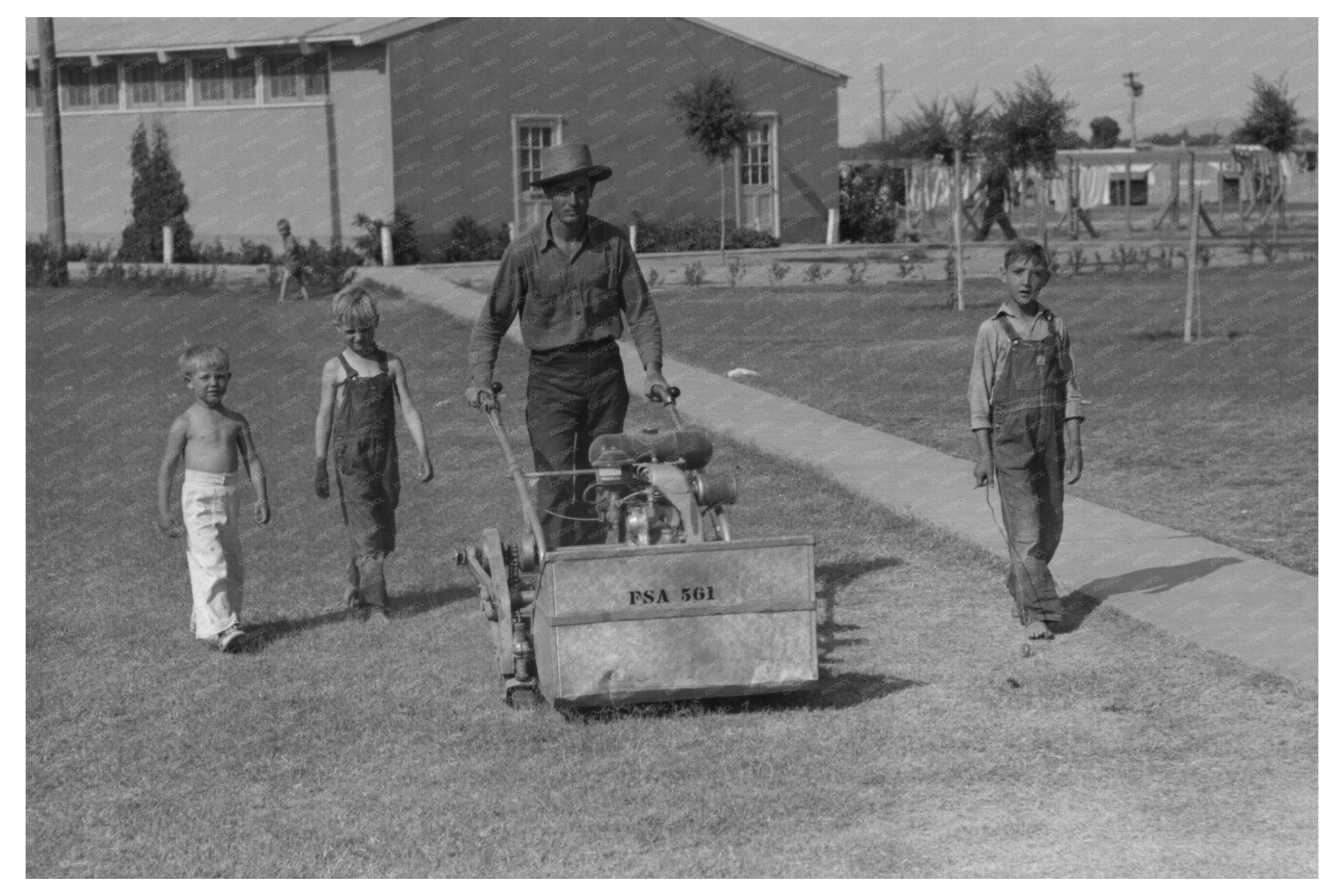 Agua Fria Migratory Labor Camp Worker Mowing Grass 1940 - Available at KNOWOL