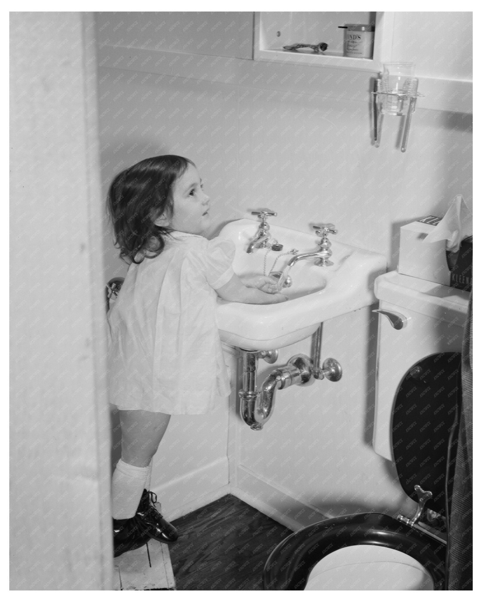 Ann Heath Washing Hands in Bantam Housing Unit 1942 - Available at KNOWOL