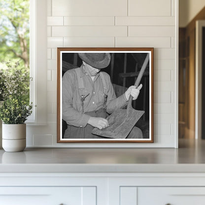 Barn Boss Cleaning Shovel at Logging Camp 1937 - Available at KNOWOL