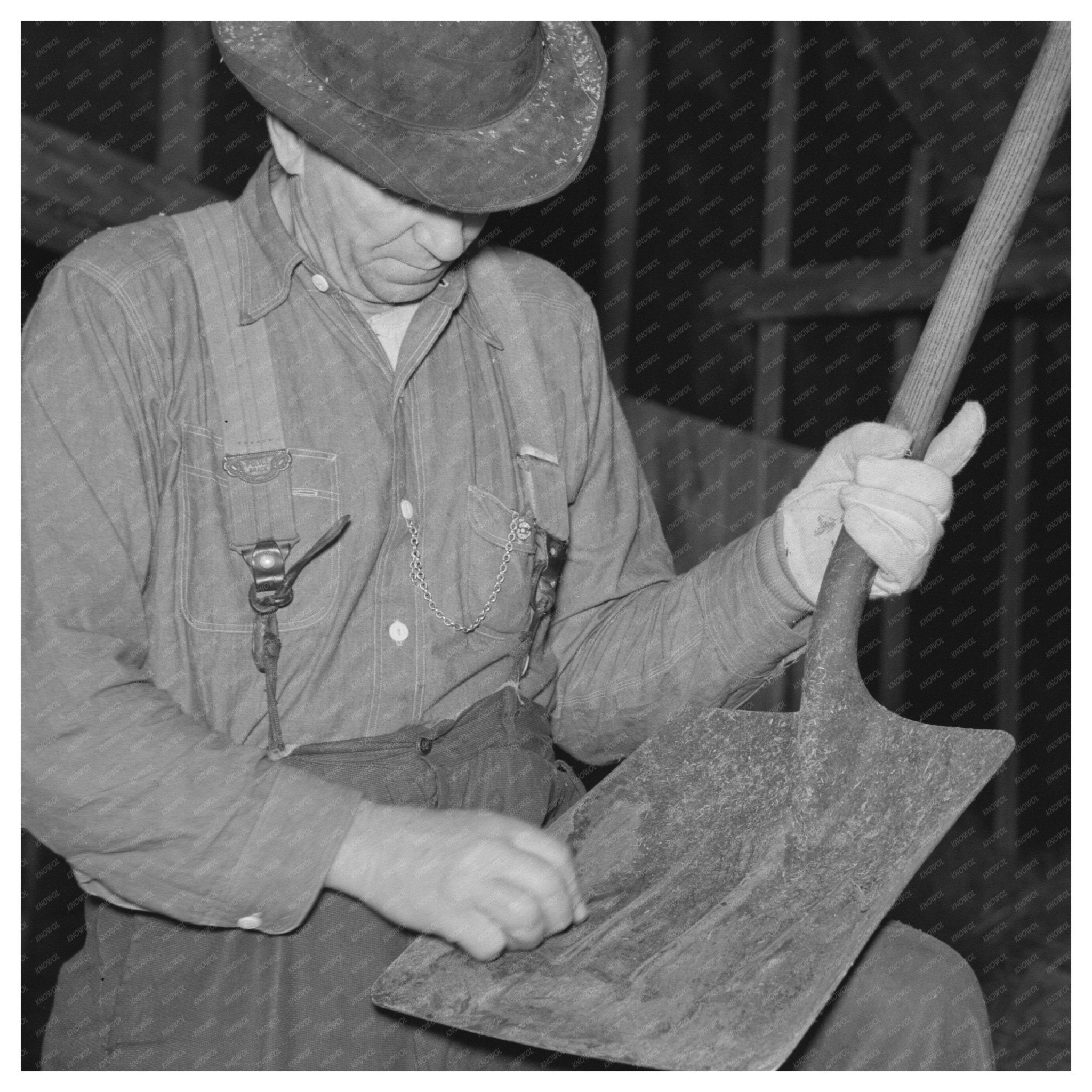 Barn Boss Cleaning Shovel at Logging Camp 1937 - Available at KNOWOL