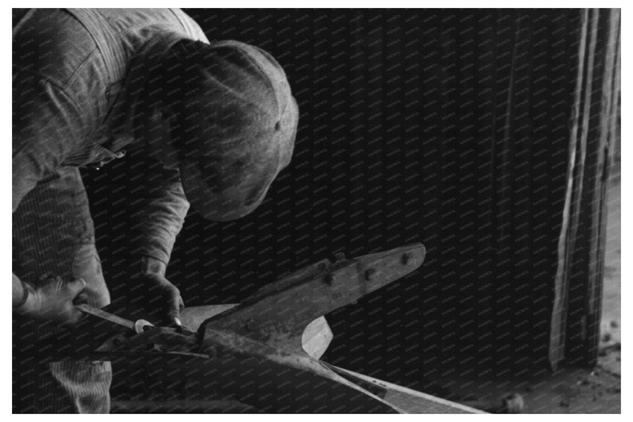 Blacksmith Helper Disassembling Plow Depew Oklahoma 1940 - Available at KNOWOL