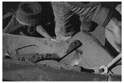 Blacksmiths Helper Disassembling Plow 1940 - Available at KNOWOL