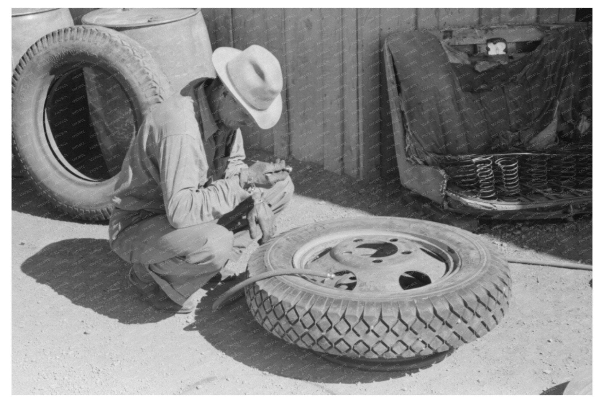 Changing a Tire at a Garage in Pie Town New Mexico 1940 - Available at KNOWOL