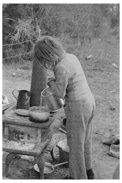 Child Adding Water to Boiling Beans in Texas Camp 1939 - Available at KNOWOL