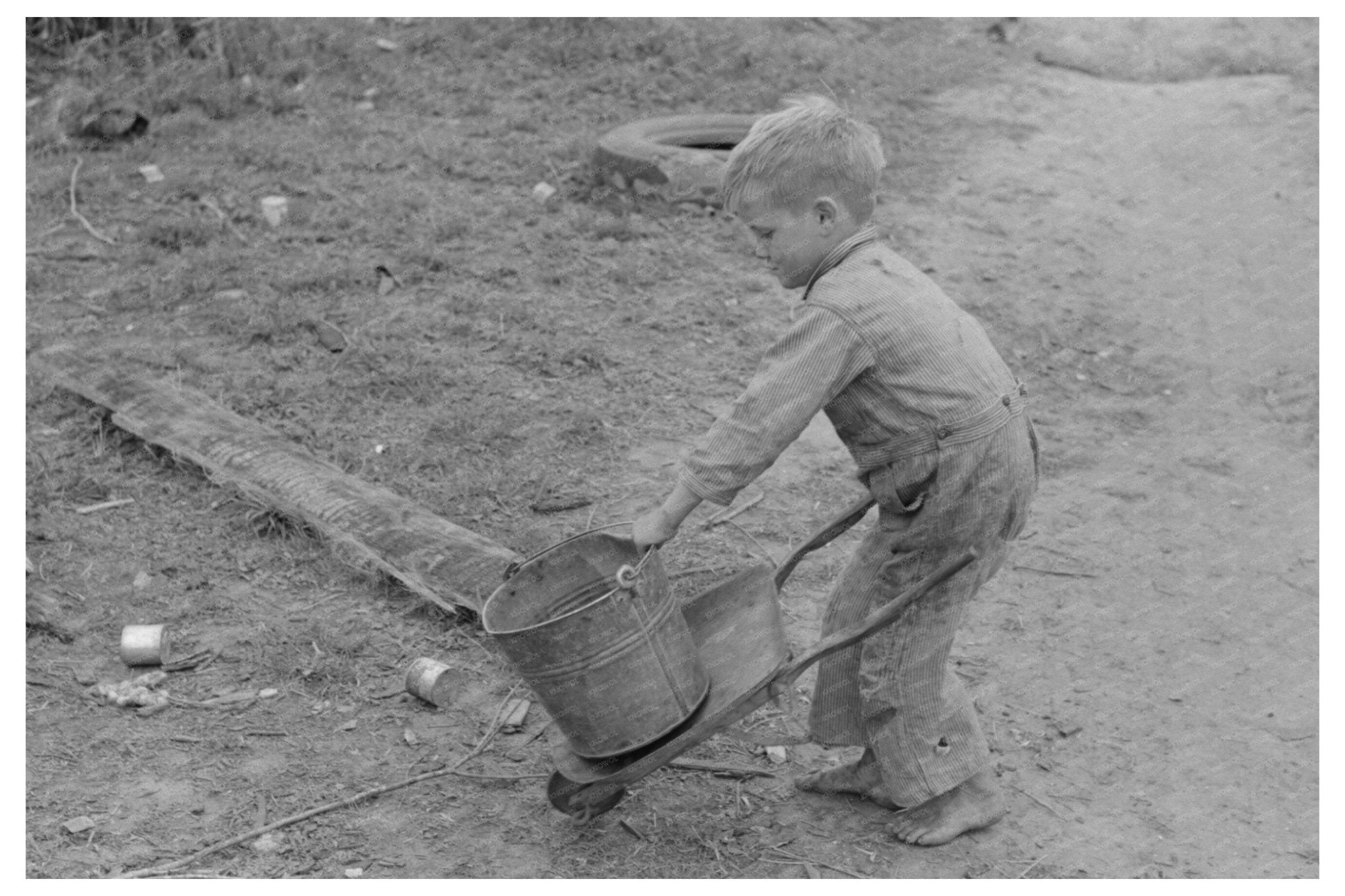 Child of Migrant Worker Playing with Tools 1939 - Available at KNOWOL