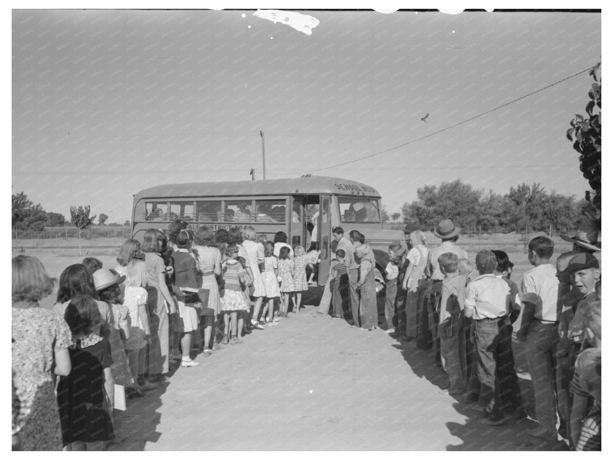 Children Boarding School Bus at Agua Fria Camp 1944 - Available at KNOWOL