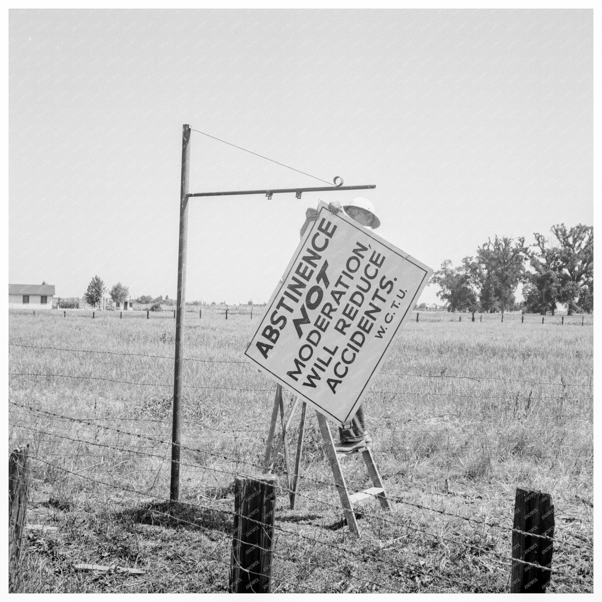 Committee Member Erecting Sign on Highway 99 May 1939 - Available at KNOWOL