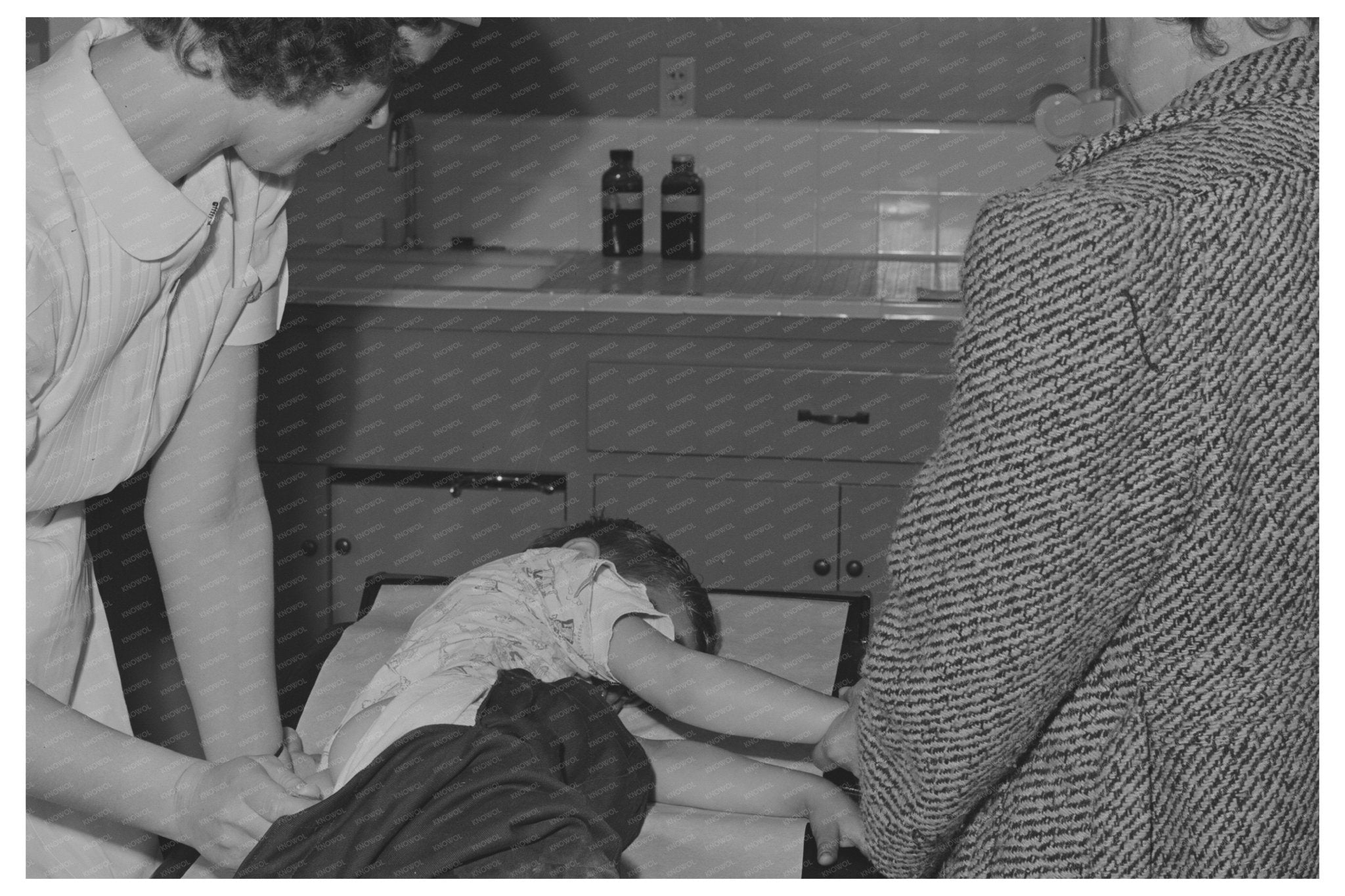 Doctor Examines Child of Farm Workers Woodville 1942 - Available at KNOWOL