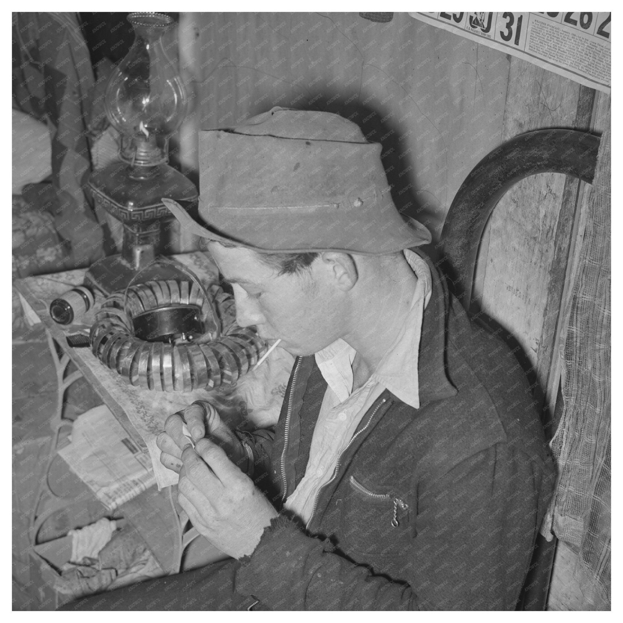 Farm Boy Rolling Cigarette at Party McIntosh County 1940 - Available at KNOWOL