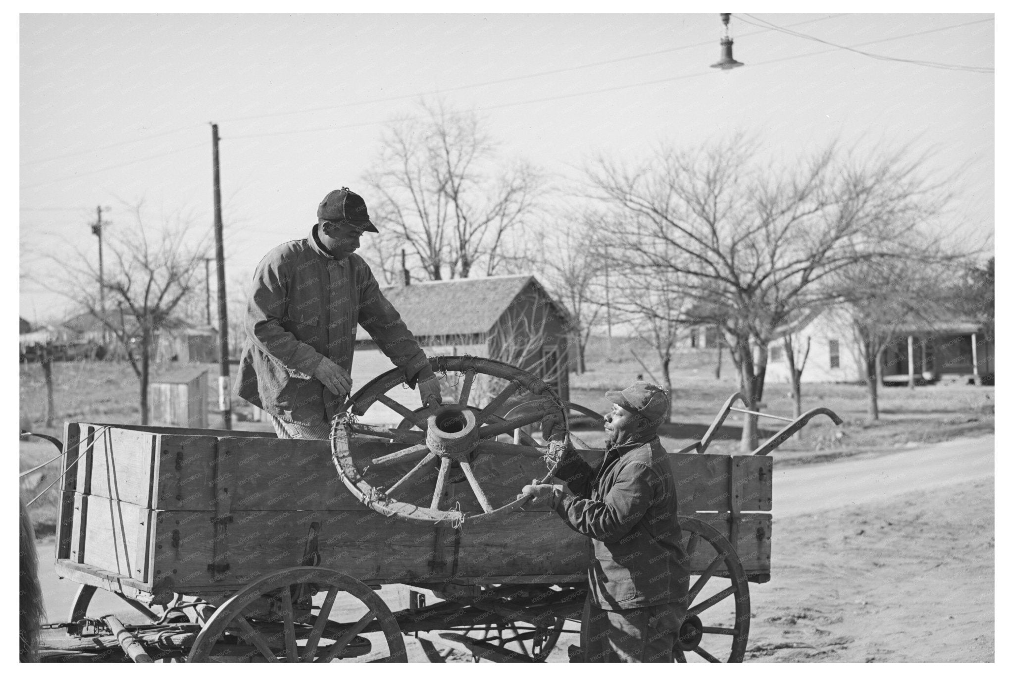 Farmer Repairs Wagon Wheel in Depew Oklahoma 1940 - Available at KNOWOL