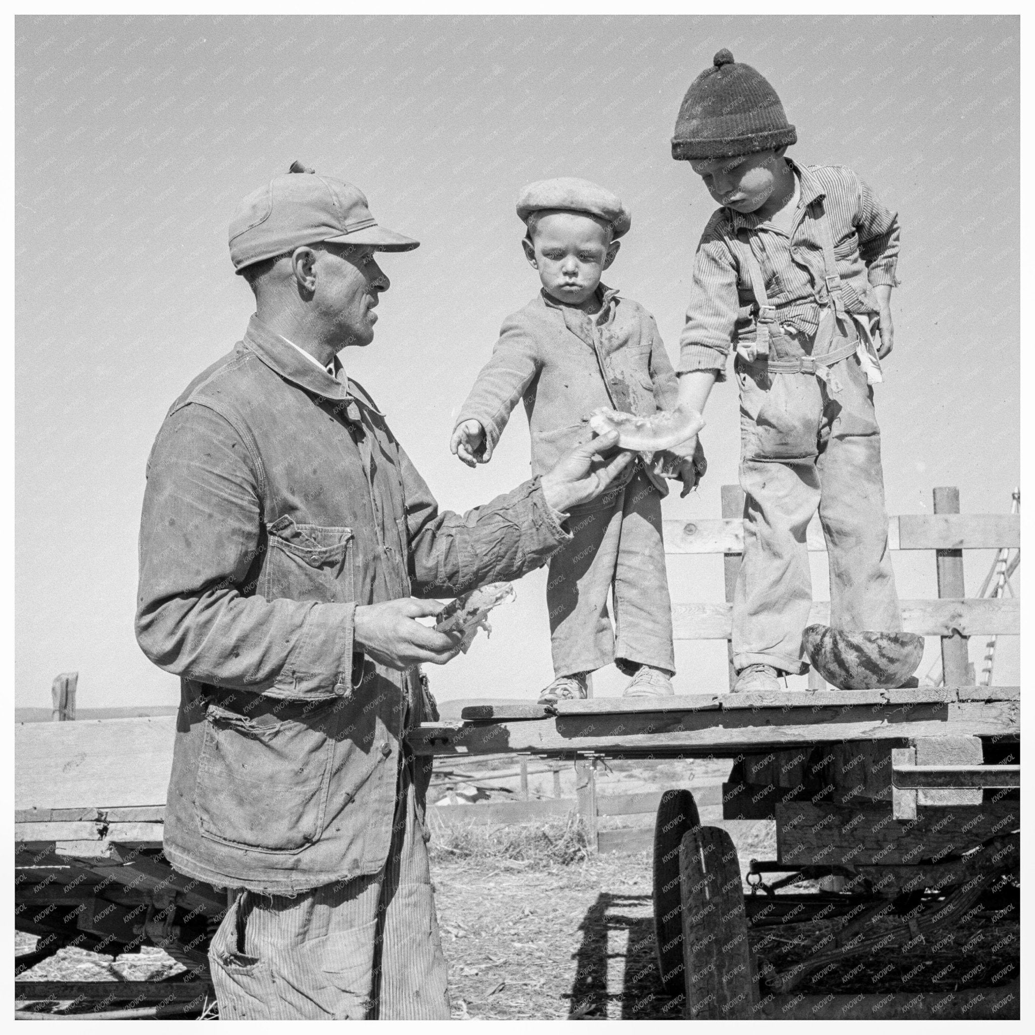 Franklin Schroeder with Sons Enjoying Watermelon 1939 - Available at KNOWOL