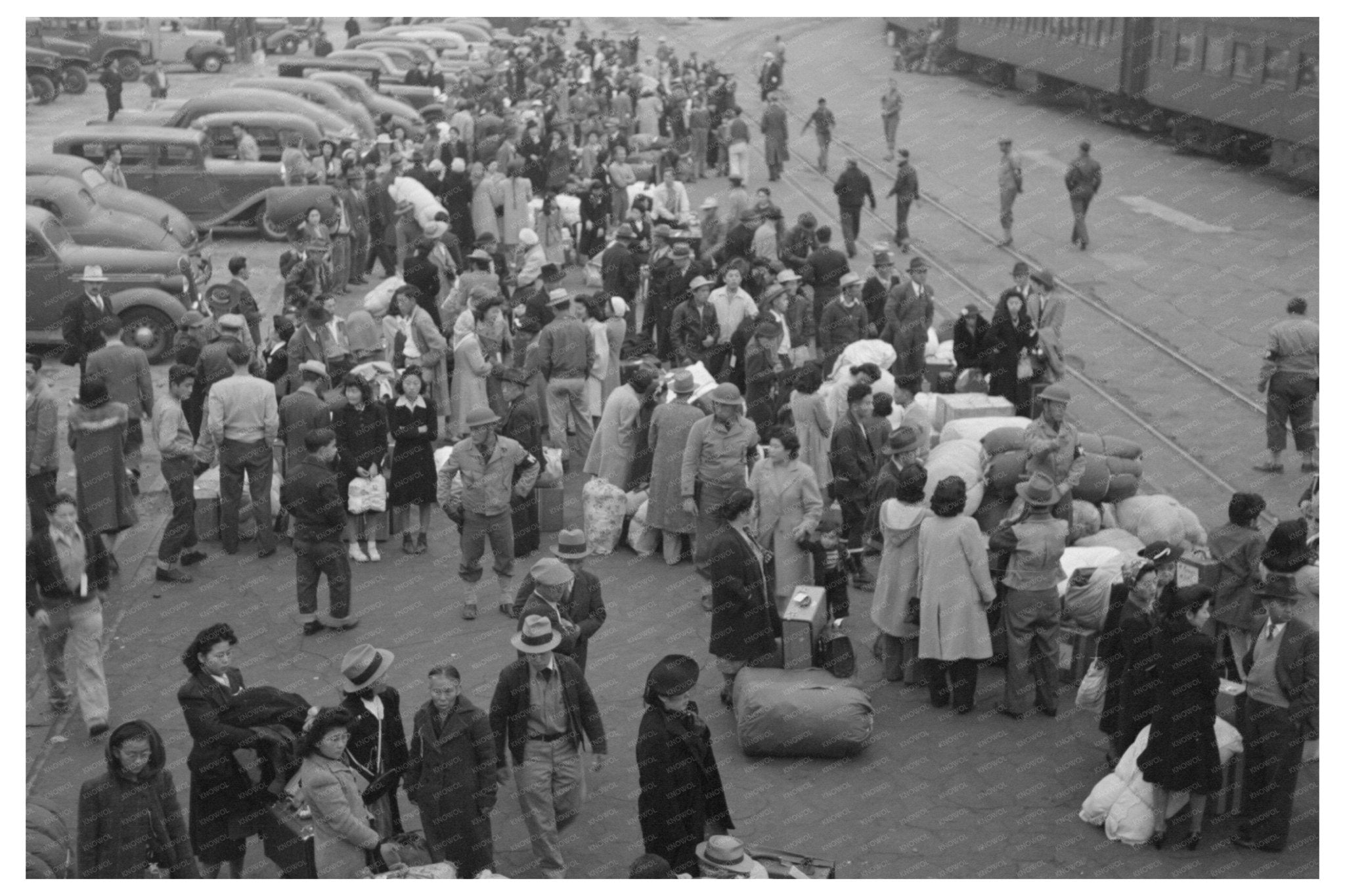 Japanese - Americans Await Train During WWII Evacuation 1942 - Available at KNOWOL