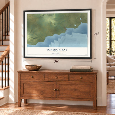 Toksook Bay, Alaska map, 24 x 36 inch print in a black frame above a dresser by a staircase