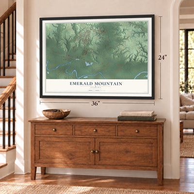 Emerald Mountain, Alabama map, 24 x 36 inch print in a black frame above a dresser by a staircase
