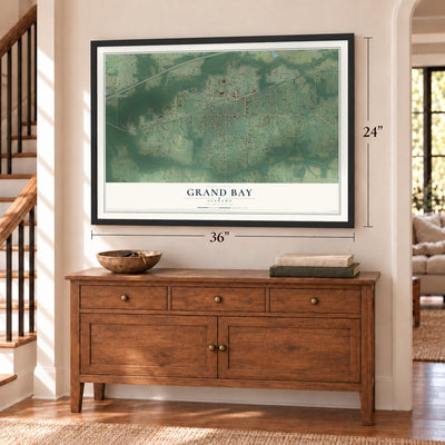 Grand Bay, Alabama map, 24 x 36 inch print in a black frame above a dresser by a staircase