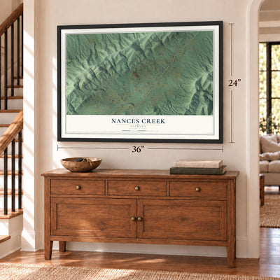 Nances Creek, Alabama map, 24 x 36 inch print in a black frame above a dresser by a staircase