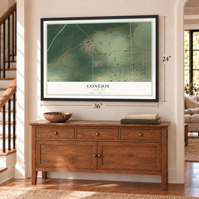 Conejos, Colorado map, 24 x 36 inch print in a black frame above a dresser by a staircase
